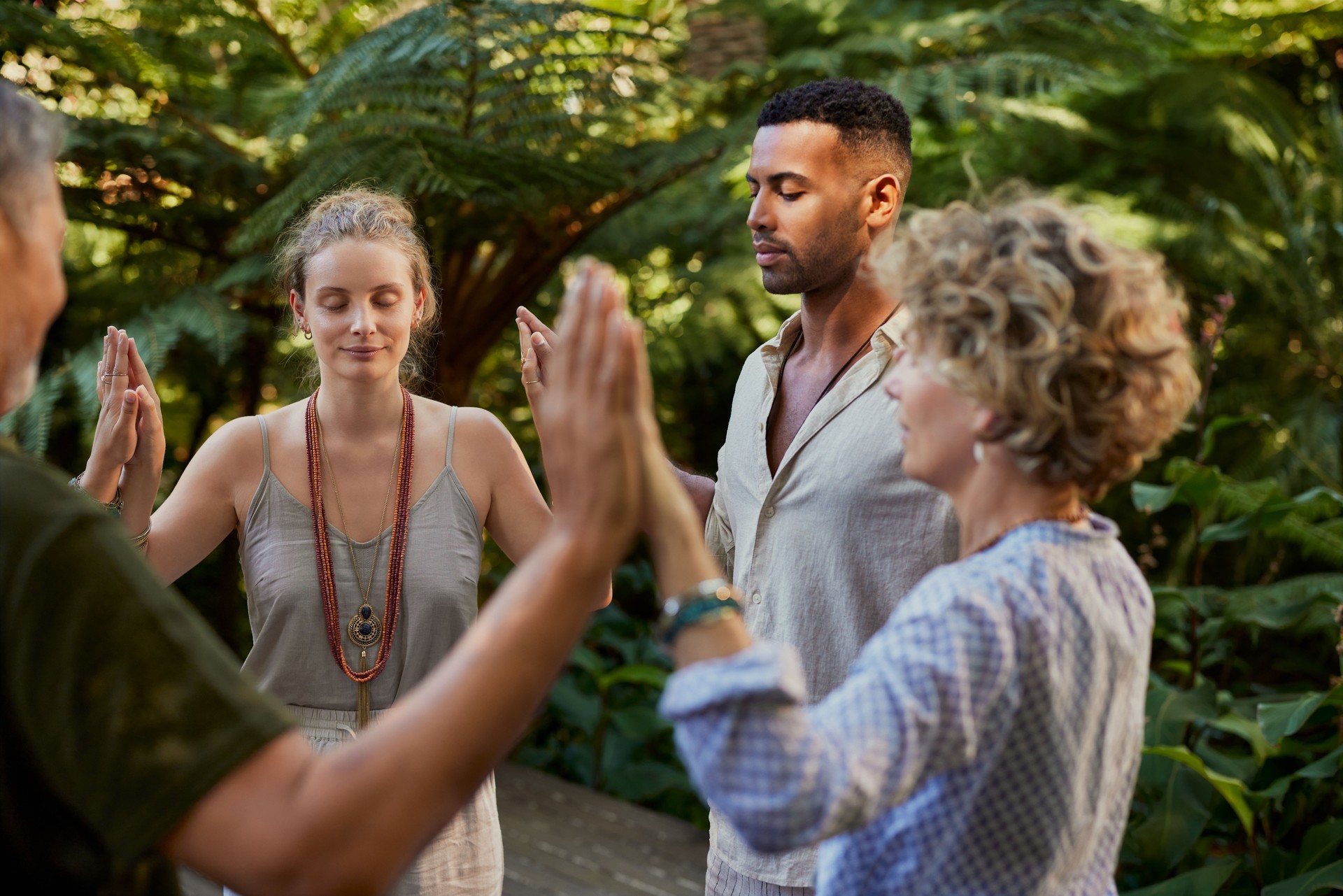People in circle passing energy and praying together People in circle passing energy and praying together